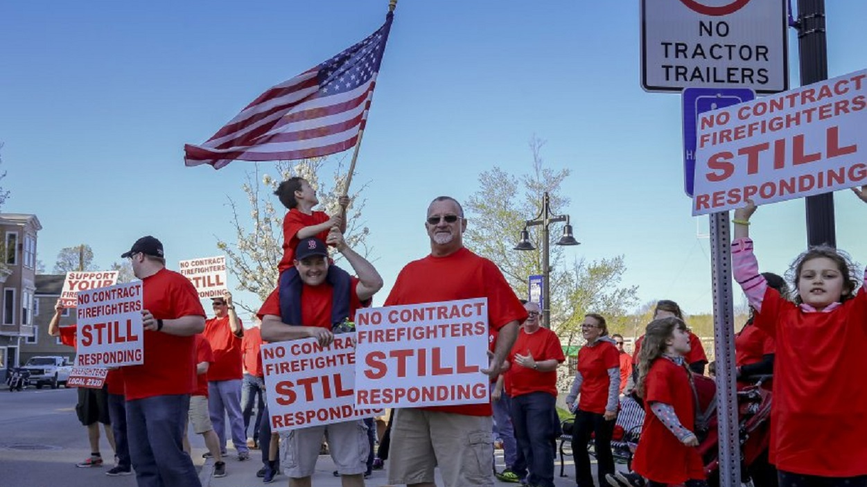 Firefighters and their supporters gather in protest on Monday, May 7, 2018, in Somerset, NH.