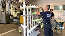 Laundered pieces of turnout gear are hung on a rack designed by a Toledo, OH, firefighter to speed up drying time and encourage colleagues to more frequently wash their gear.