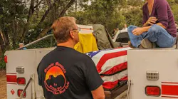 Amanda speaks with Duane Steinbrink, Wildland Division Chief of the Prescott Fire Department, while sitting with Eric’s casket before his funeral.