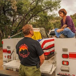 Amanda speaks with Duane Steinbrink, Wildland Division Chief of the Prescott Fire Department, while sitting with Eric’s casket before his funeral. Amanda speaks with Duane Steinbrink, Wildland Division Chief of the Prescott Fire Department, while sitting with Eric’s casket before his funeral.