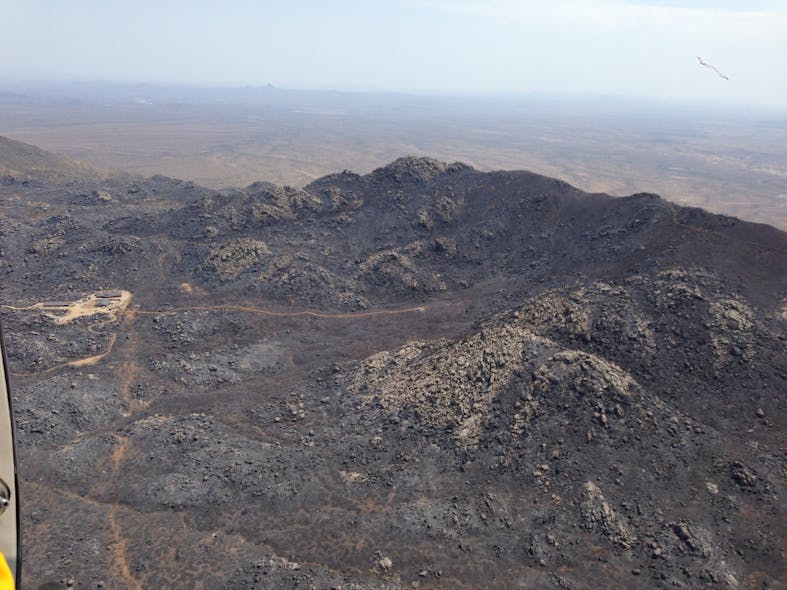 The crew left the road (upper right) and hiked down into an unburned box canyon, taking the most direct route to a ranch, which was a safety zone (left), on the edge of town. Note: The dozer line to the deployment site was constructed for access after the entrapment.