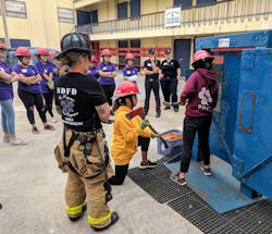 Teens participate in a forcible-entry drill at the Girls Empowerment Camp. Teens participate in a forcible-entry drill at the Girls Empowerment Camp.