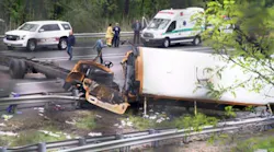A mangled school bus lays on its side on I-80 in Mount Olive, NJ, after colliding with a dump truck on Thursday, May 17, 2018.