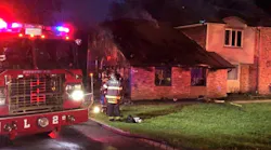Firefighters remain on scene after battling a fire at a large two-story home in Syosset, NY, on Tuesday, May 29, 2018.