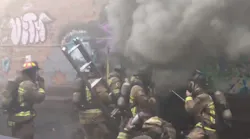 Atlanta firefighters begin to make entry into a burning three-story building where a crew member fell through the floor and signaled a mayday on Monday, June 11, 2018.