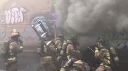 Atlanta firefighters begin to make entry into a burning three-story building where a crew member fell through the floor and signaled a mayday on Monday, June 11, 2018. Atlanta firefighters begin to make entry into a burning three-story building where a crew member fell through the floor and signaled a mayday on Monday, June 11, 2018.