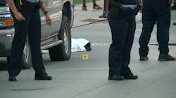 Chicago police officers stand near 17-year-old Erin Carey after the teen was shot multiple times in the head on Monday, June 18, 2018, and covered with a sheet because paramedics mistakenly believed he was dead. Chicago police officers stand near 17-year-old Erin Carey after the teen was shot multiple times in the head on Monday, June 18, 2018, and covered with a sheet because paramedics mistakenly believed he was dead.