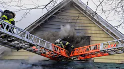 FDNY firefighters operating atop a ladder during a house fire on April 11, 2018.