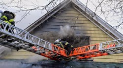 FDNY firefighters operating atop a ladder during a house fire on April 11, 2018. FDNY firefighters operating atop a ladder during a house fire on April 11, 2018.