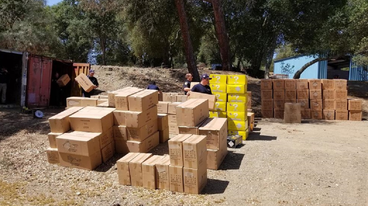 Cal Fire firefighters transport boxes of fireworks that were seized as part of a three-year investigation resulting in the arrests of seven people and the confiscation of nearly 50,000 pounds of illegal fireworks.
