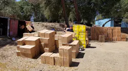 Cal Fire firefighters transport boxes of fireworks that were seized as part of a three-year investigation resulting in the arrests of seven people and the confiscation of nearly 50,000 pounds of illegal fireworks.