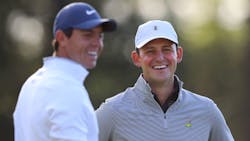 Brockton, MA, firefighter Matt Parziale, right, shares a laugh with professional golfer Rory McIlroy during a practice round for the Masters on April 2, 2018, in Augusta, GA.