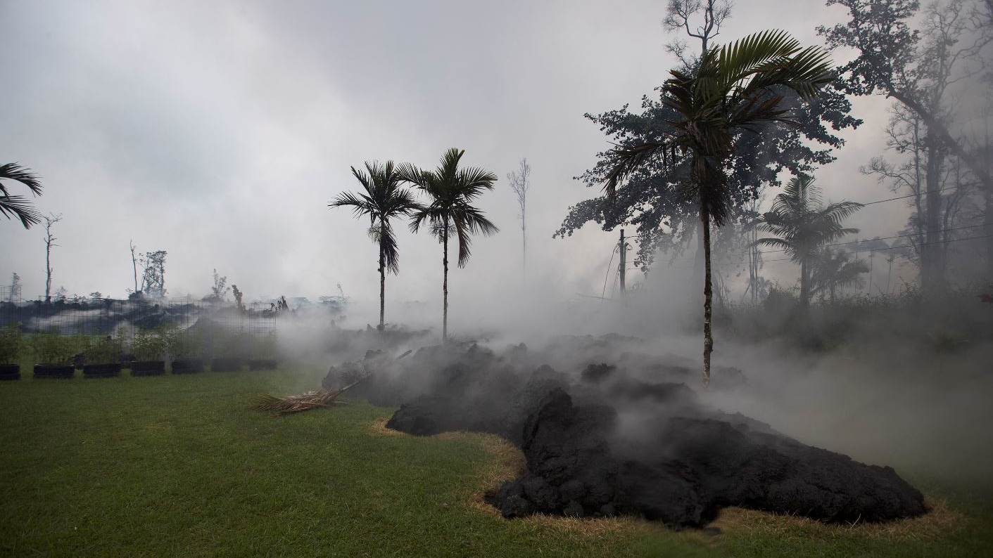 Lava flows inside the Leilani Estates neighborhood on the Big Island in Hawaii on May 10, 2018.