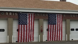 The Morris Volunteer Fire Department has American flags draped over its apparatus bay doors after members voted on June 19, 2018, to cease providing services on June 30.