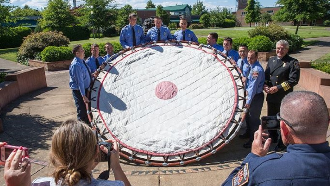 Eugene Springfield, OR, fire recruits present Fire Chief Joe Zaludek with a restored Browder life safety net during graduation ceremonies on Friday, June 29, 2018.