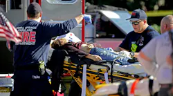 Coral Springs-Parkland Fire Department paramedics tend to a victim outside Marjory Stoneman Douglas High School in Parkland, FL, after a shooting on Feb. 14, 2018.