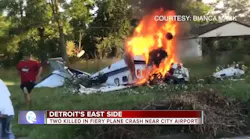 An injured man wearing a red shirt runs away from a plane wreckage in Detroit on Sunday, June 24, 2018, that killed two people.