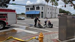 Lakeland firefighters assist two seniors during an evacuation of the Lake Morton Plaza assisted living facility due to a fire on the roof on Tuesday, June 26, 2018.