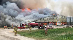 Firefighters on scene during a massive fire that destroyed two barns and killed as many as 5,000 pigs at a hog farm in Wayne Township, OH, on Tuesday, June 19, 2018.