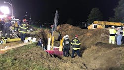 Rescue crews digging out a trench to recover the body of a construction worker who was killed in a collapse in Baltimore, MD, on Tuesday, June 5, 2018.