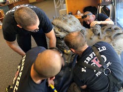 Fairfield firefighters chip away at a stone statue as they free a boy whose head became stuck while he was trying to crawl through it on Monday, June 25, 2018.