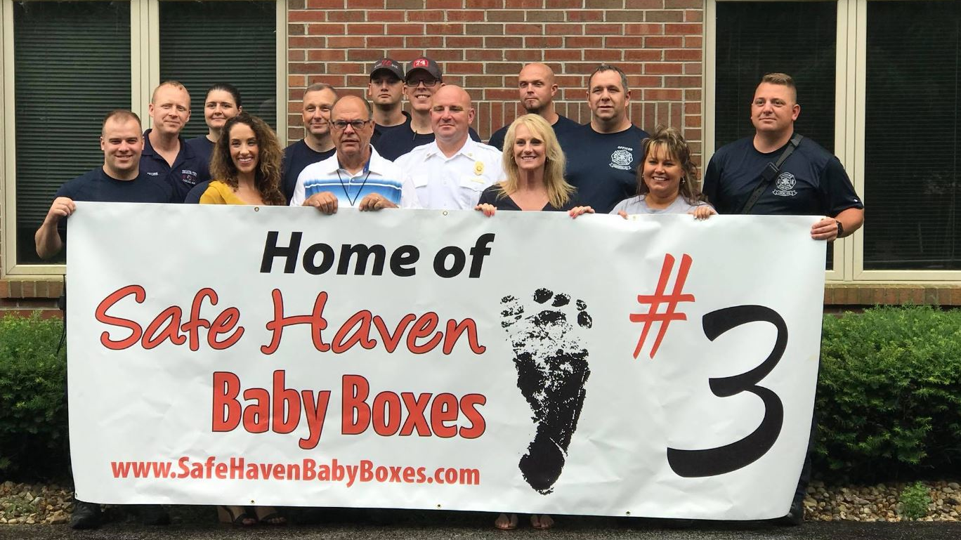 Decatur Township firefighters pose for photos after it was announced on June 21, 2018, that their station would install a 'Safe Haven Baby Box.'