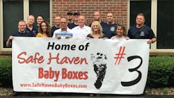 Decatur Township firefighters pose for photos after it was announced on June 21, 2018, that their station would install a &apos;Safe Haven Baby Box.&apos;