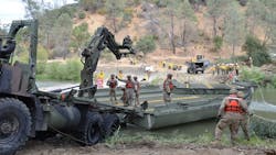 Cal Fire crews watch as members of the California National Guard build a temporary bridge across Cache Creek in Yolo County to assist them during firefighting operations. Cal Fire crews watch as members of the California National Guard build a temporary bridge across Cache Creek in Yolo County to assist them during firefighting operations.