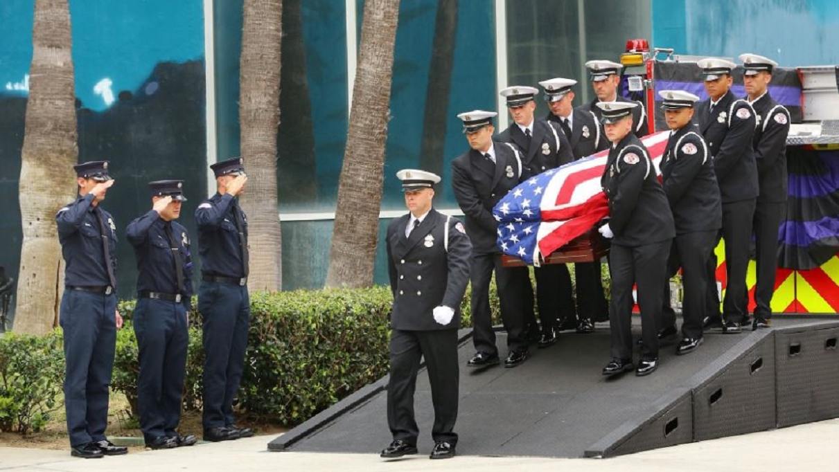 The casket of fallen Long Beach fire Capt. David Rosa is carried by his fellow firefighters during a memorial service at the Long Beach Convention Center on Tuesday, July 3, 2018.