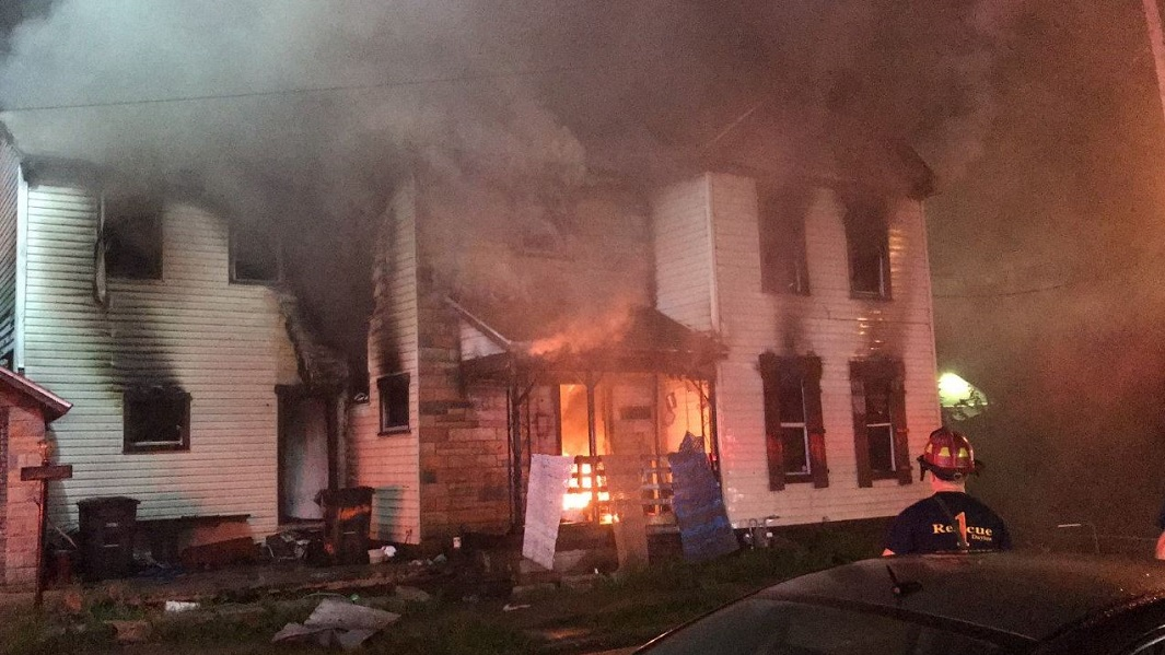 A vacant home in Dayton, OH, burns on Tuesday, July 31, 2018.