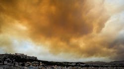 Smoke hovers over the ancient Acropolis hill as a wildfire burns west of Athens, Greece, on Monday, July 23, 2018. Smoke hovers over the ancient Acropolis hill as a wildfire burns west of Athens, Greece, on Monday, July 23, 2018.