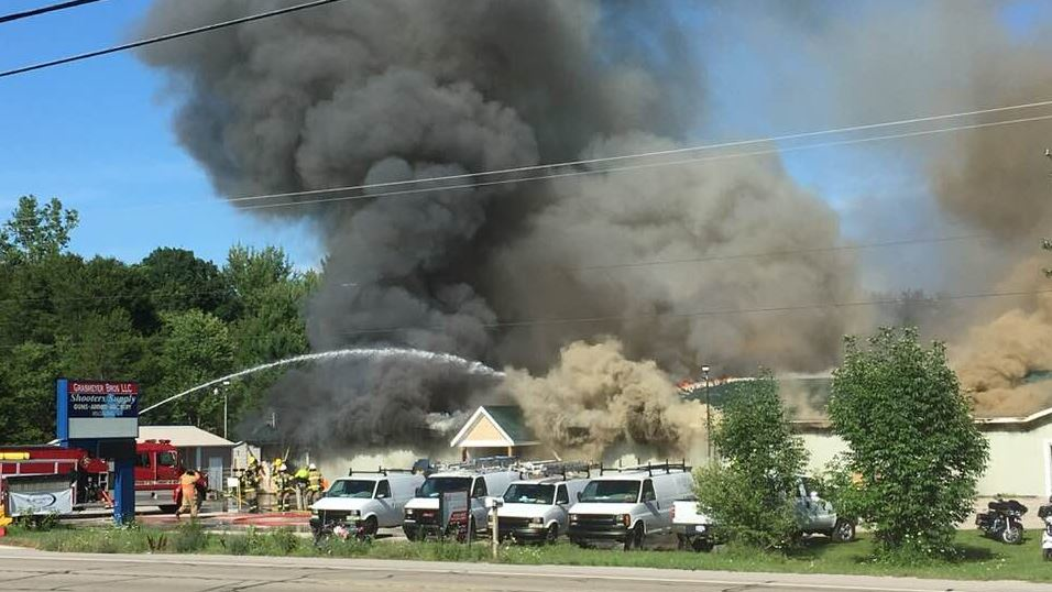 Firefighters battling a blaze that engulfed a Twin Lake, MI, gun shop on Wednesday, July 25, 2018.