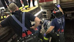 Cambridge firefighters work to rescue a woman who became trapped between an MBTA train and the platform at Central Square station on Thursday, July 12, 2018. Cambridge firefighters work to rescue a woman who became trapped between an MBTA train and the platform at Central Square station on Thursday, July 12, 2018.