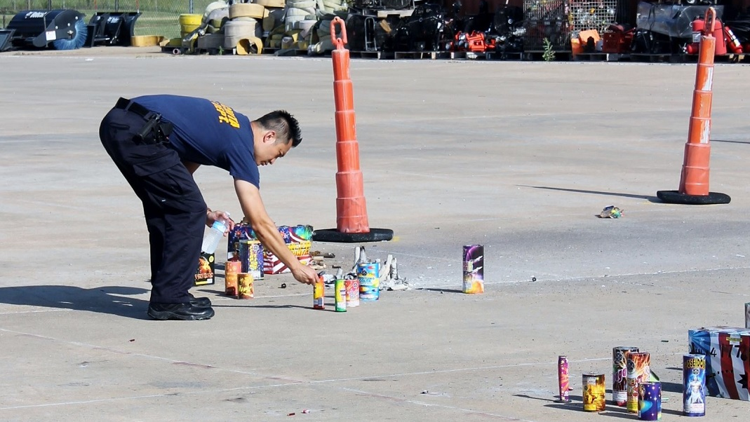 A Wichita firefighter checks to make sure fireworks debris has been properly extinguished on Thursday, July 5, 2018.