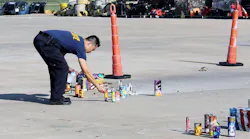 A Wichita firefighter checks to make sure fireworks debris has been properly extinguished on Thursday, July 5, 2018.