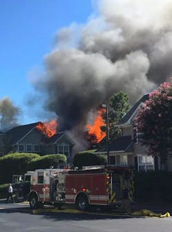 Firefighters battle a blaze in Williamsburg townhome complex following a possible helicopter crash.