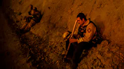 A firefighter takes a break during a burn operation near the town of Ladoga, CA, during the Mendocino Fire.