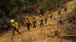 Firefighters from S&R Contracting in Oregon walk the fire line as they head toward their assignment on the Carr Fire near Redding, CA, on Monday, July 30, 2018. Firefighters from S&R Contracting in Oregon walk the fire line as they head toward their assignment on the Carr Fire near Redding, CA, on Monday, July 30, 2018.