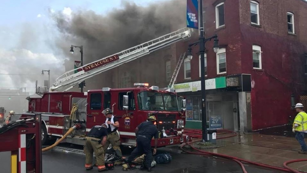 Syracuse firefighters on scene during an apartment building fire on Wednesday, Aug. 29, 2018.