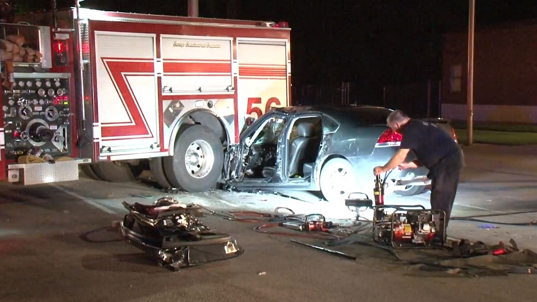 A vehicle rests partially wedged beneath a Houston Fire Department apparatus after slamming into it while it was backing into a station on Wednesday, Aug. 15, 2018.