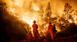 Cal Fire firefighters monitor a burn operation on top of a ridge near the town of Ladoga, CA, on Aug. 7, 2018.