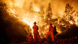 Cal Fire firefighters monitor a burn operation on top of a ridge near the town of Ladoga, CA, on Aug. 7, 2018.