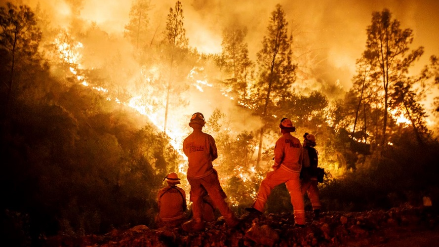 Firefighters monitor a burn operation on top of a ridge near the town of Ladoga, CA, on Aug. 7, 2018.