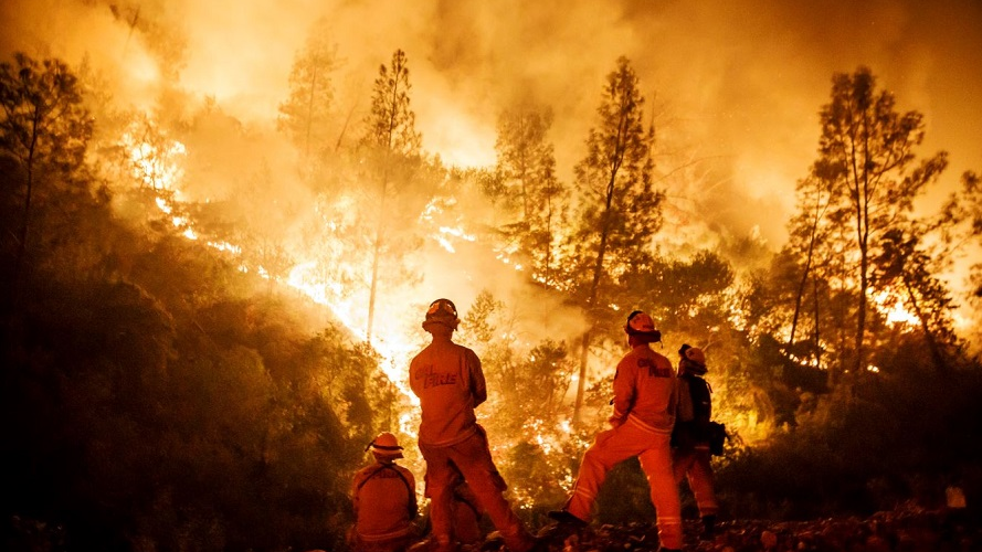 Firefighters monitor a burn operation on top of a ridge near the town of Ladoga, CA, on Aug. 7, 2018.