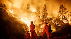 Firefighters monitor a burn operation on top of a ridge near the town of Ladoga, CA, on Aug. 7, 2018.