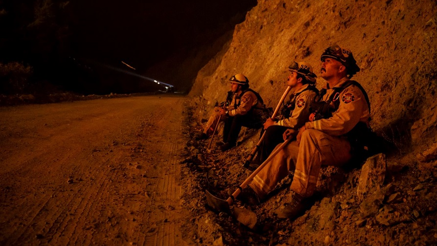 Firefighters monitor a burn operation on top of a ridge near the town of Ladoga, CA, on Aug. 7, 2018.