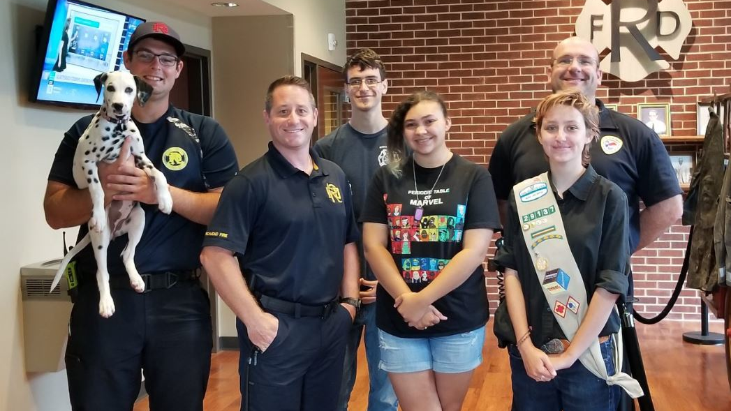 Richmond firefighters pictured with a group of youngsters who recently taught them about the benefits of learning American Sign Language.