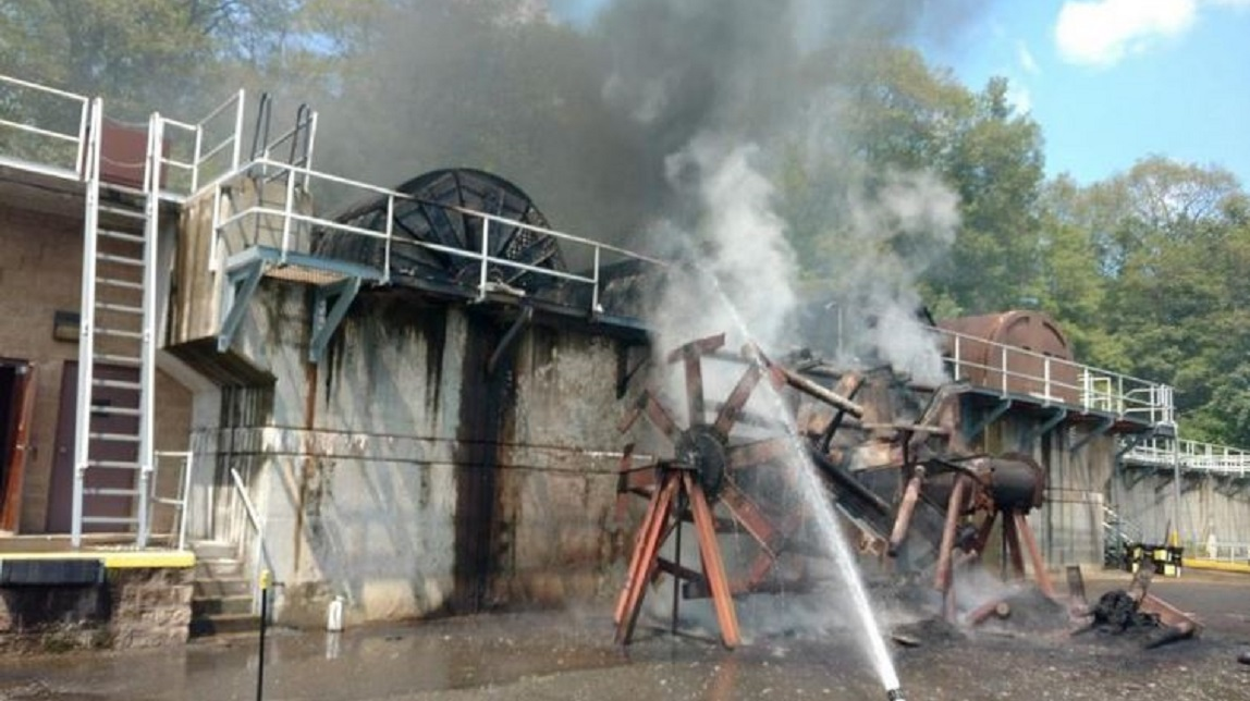 Firefighters pour water on a fire that broke out at a sewage treatment plant in Highland Falls, NY, on Wednesday, Aug. 15, 2018.