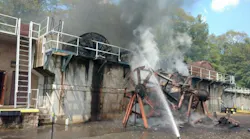 Firefighters pour water on a fire that broke out at a sewage treatment plant in Highland Falls, NY, on Wednesday, Aug. 15, 2018.