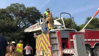 Plattsmouth firefighters extend an aerial ladder during a rescue of a skydiver who crashed into a tree and got stuck 70 feet up for three hours on Saturday, Aug. 25, 2018.